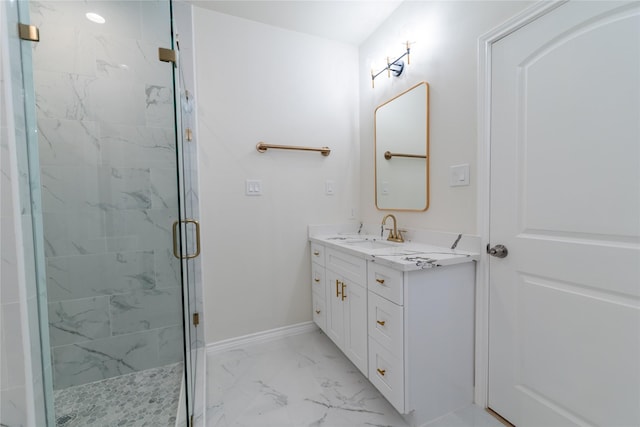 bathroom with marble finish floor, a marble finish shower, vanity, and baseboards