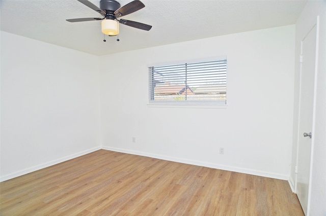 empty room featuring ceiling fan, a textured ceiling, and light wood-type flooring