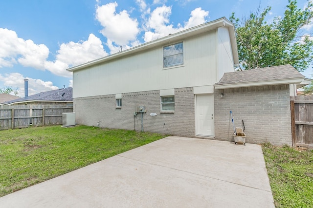 back of property featuring central AC unit, a patio area, and a lawn