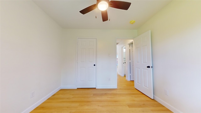 unfurnished bedroom with light hardwood / wood-style floors and ceiling fan