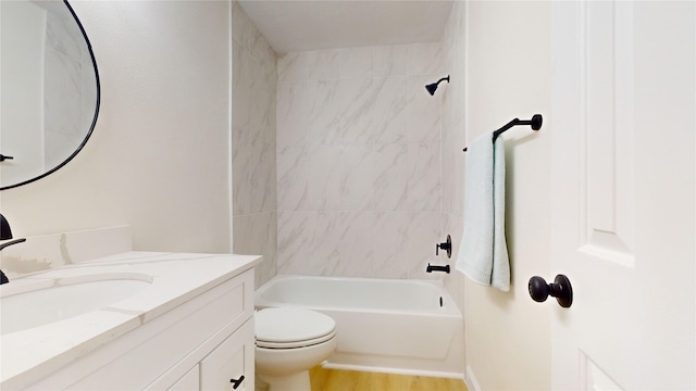 full bathroom featuring wood-type flooring, toilet, vanity, and tiled shower / bath