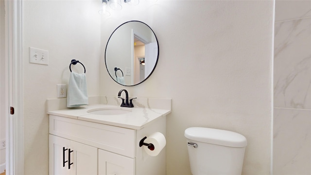 bathroom featuring toilet and vanity