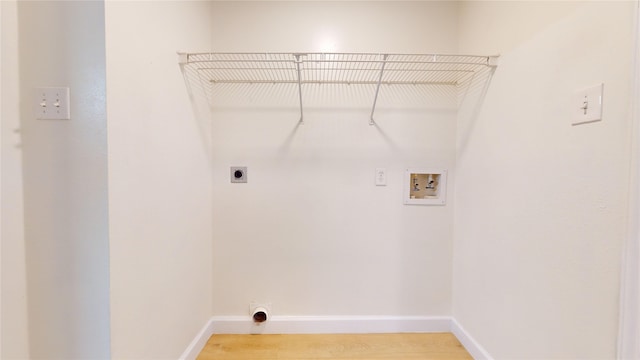 laundry area featuring washer hookup, hookup for an electric dryer, and wood-type flooring