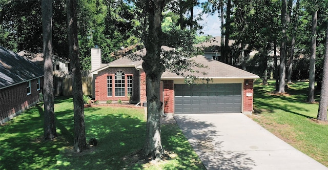 obstructed view of property featuring a garage and a front yard