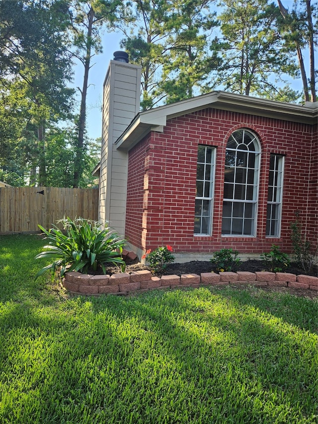 view of side of property with a lawn