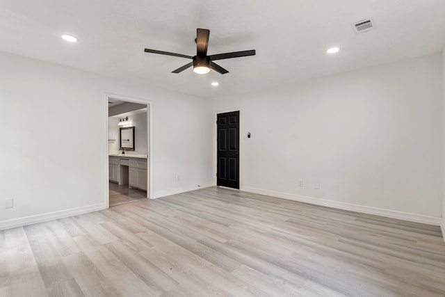 spare room featuring ceiling fan and light hardwood / wood-style flooring