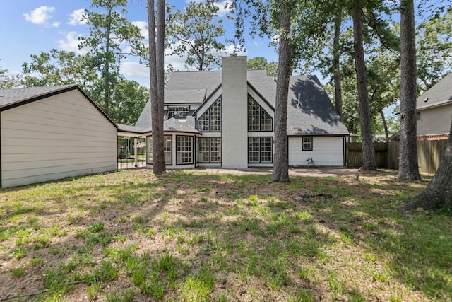 rear view of property with a patio and a yard