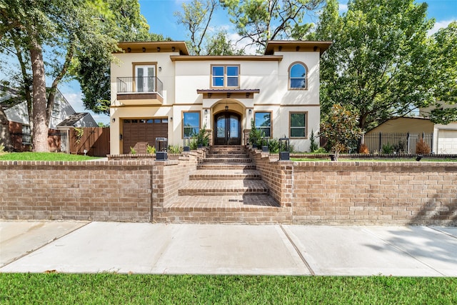 view of front of house featuring a balcony and a garage