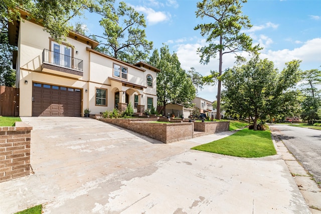 view of front of home featuring a garage and a balcony