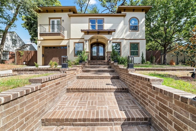 view of front of property with a balcony and a garage