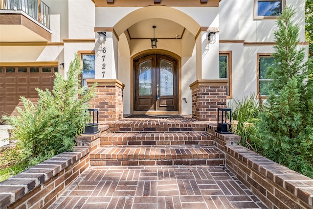 entrance to property with a balcony and french doors