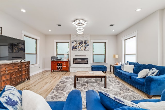 living room with light hardwood / wood-style floors and a fireplace