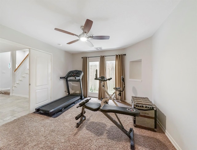 exercise area with light colored carpet and ceiling fan