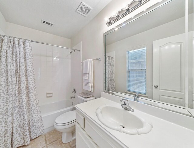 full bathroom featuring toilet, shower / bath combo with shower curtain, vanity, and tile patterned flooring