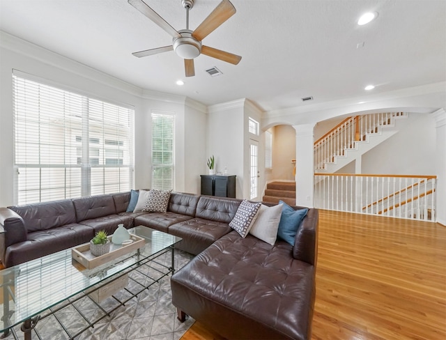 living room featuring light hardwood / wood-style flooring, crown molding, and ceiling fan