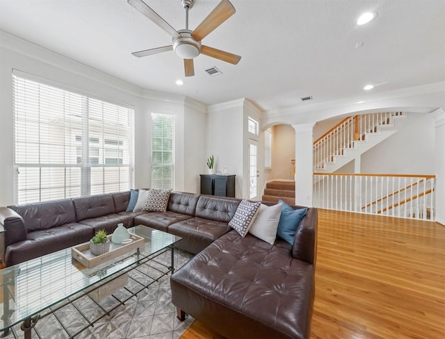 living room featuring hardwood / wood-style floors, crown molding, a healthy amount of sunlight, and ceiling fan