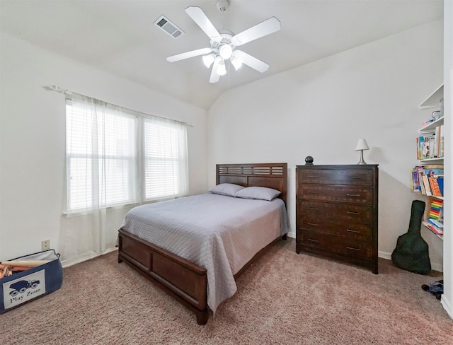 carpeted bedroom with vaulted ceiling and ceiling fan