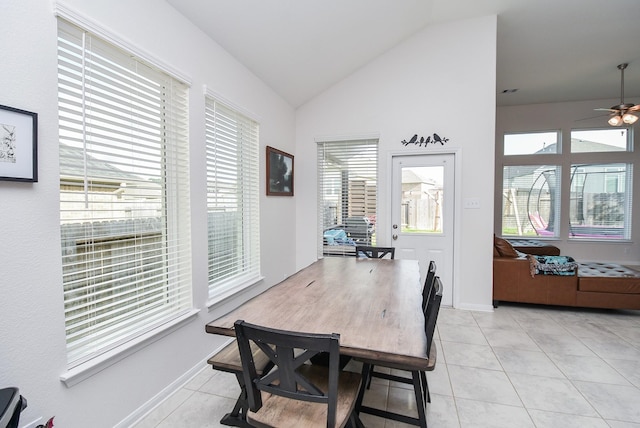 tiled dining area with lofted ceiling, ceiling fan, and plenty of natural light