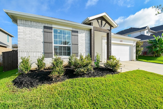 view of front of house featuring a front lawn and a garage