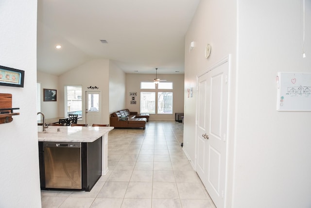 kitchen with stainless steel dishwasher, light tile patterned floors, ceiling fan, and plenty of natural light