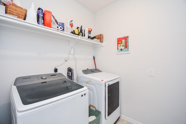 clothes washing area featuring washing machine and clothes dryer