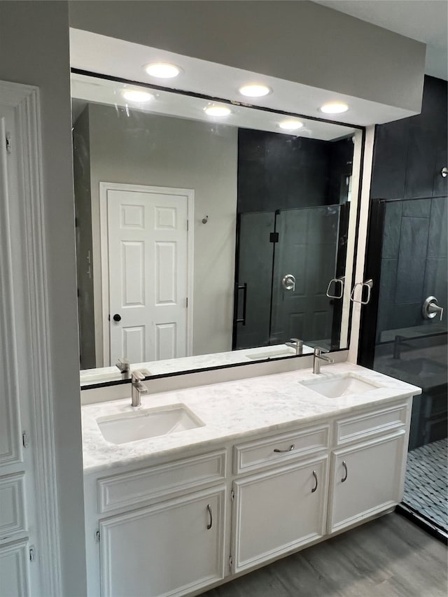 bathroom featuring hardwood / wood-style flooring and double vanity