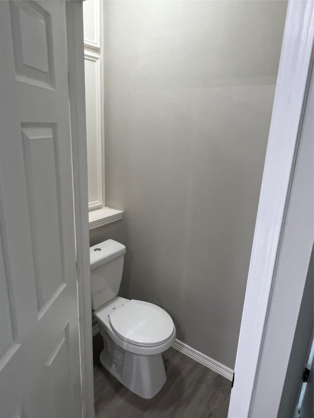 bathroom featuring wood-type flooring and toilet