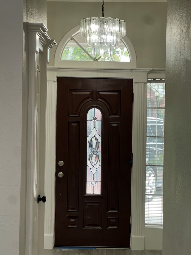 entrance foyer with an inviting chandelier and a healthy amount of sunlight