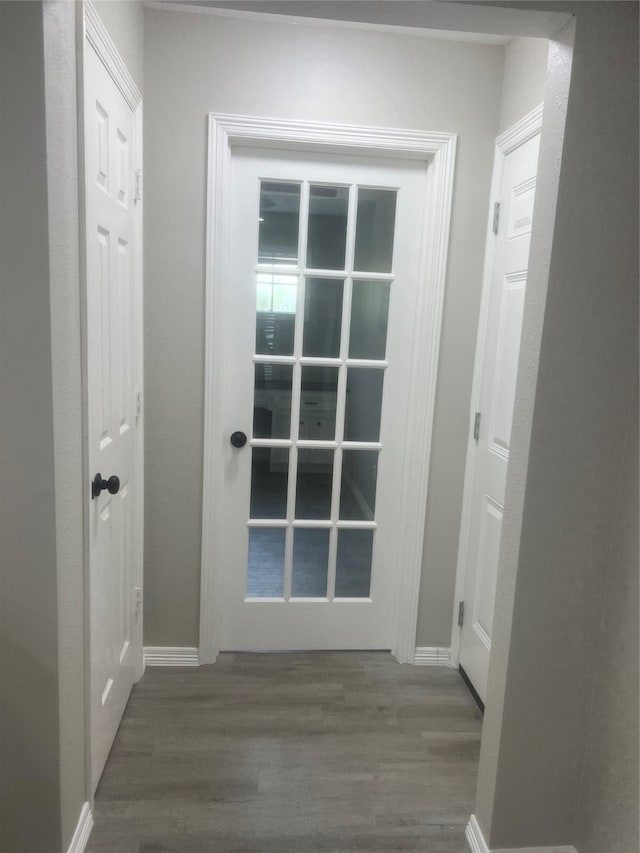 corridor with hardwood / wood-style floors