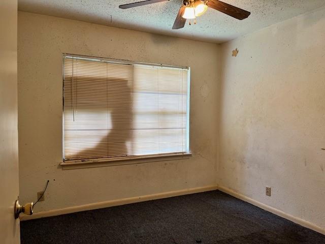 spare room with a textured ceiling, ceiling fan, and carpet flooring