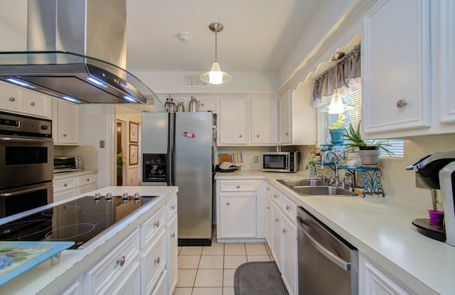 kitchen featuring white cabinetry, island range hood, light tile patterned floors, stainless steel appliances, and sink