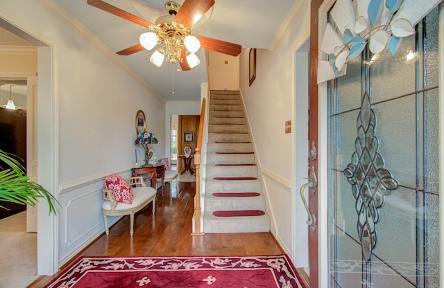 foyer entrance with ceiling fan, ornamental molding, and hardwood / wood-style floors