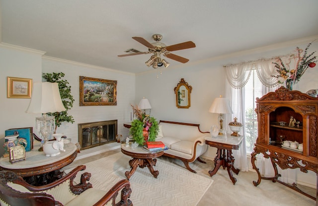 living room featuring a brick fireplace, ceiling fan, light colored carpet, and crown molding