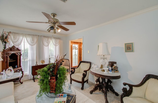 carpeted living room featuring ceiling fan and crown molding