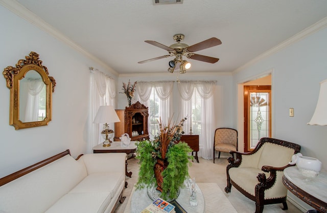 carpeted living room with ornamental molding and ceiling fan