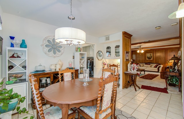 dining space with ceiling fan with notable chandelier and light tile patterned floors