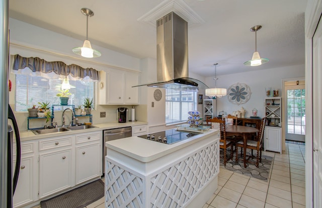 kitchen with hanging light fixtures, island range hood, white cabinetry, and black electric stovetop