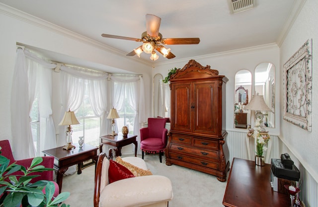 sitting room featuring ceiling fan, light colored carpet, and ornamental molding