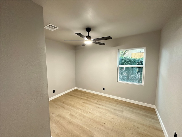 spare room featuring light hardwood / wood-style floors and ceiling fan