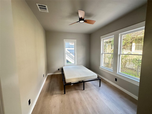 bedroom with light hardwood / wood-style flooring and ceiling fan