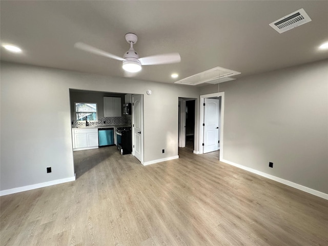 unfurnished living room with light hardwood / wood-style flooring and ceiling fan