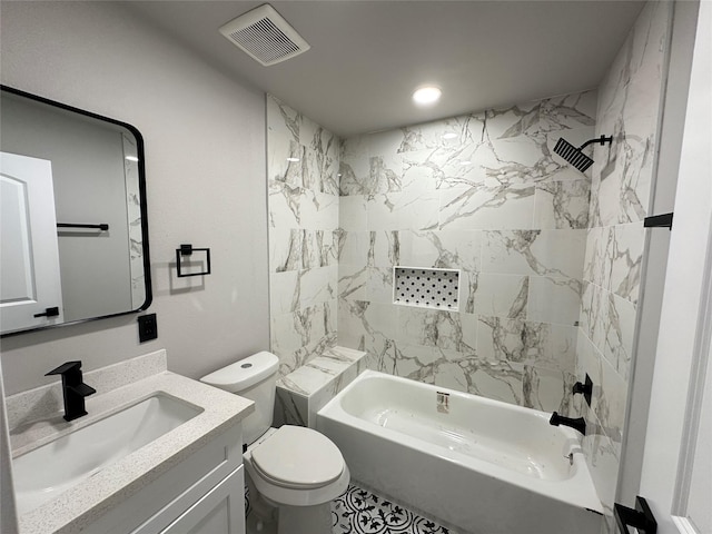 full bathroom featuring vanity, toilet, and tiled shower / bath