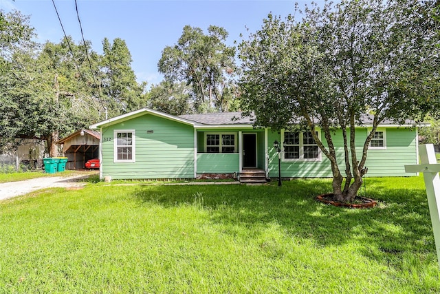 ranch-style house featuring a carport and a front yard