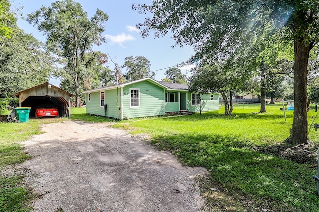 view of front of home with a carport and a front yard