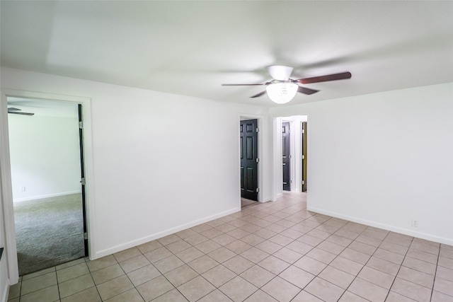 tiled spare room with ceiling fan