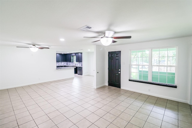 tiled empty room with ceiling fan