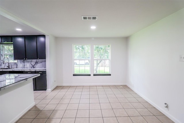 kitchen featuring sink and light tile patterned floors