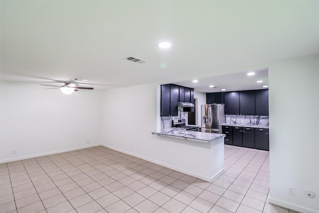 kitchen featuring light tile patterned floors, kitchen peninsula, ceiling fan, and appliances with stainless steel finishes