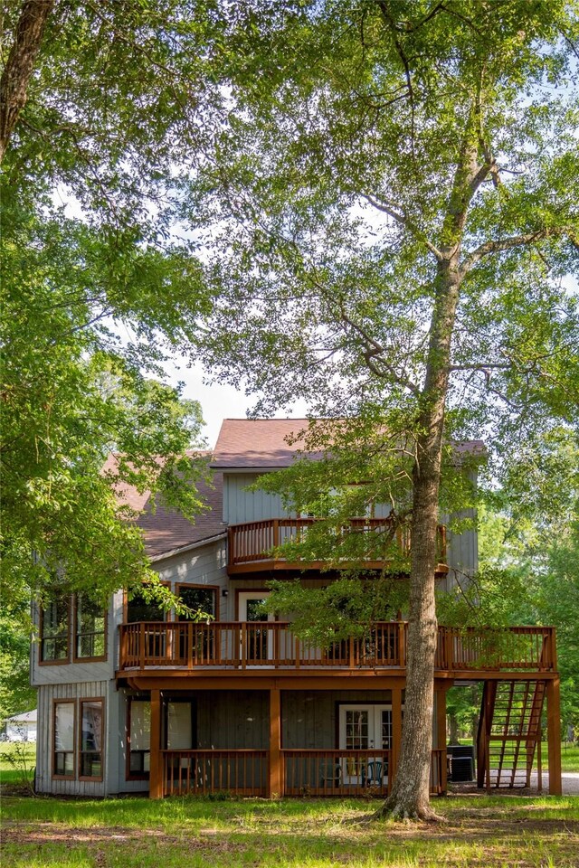 rear view of property with a wooden deck