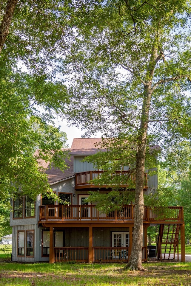 back of property featuring a wooden deck